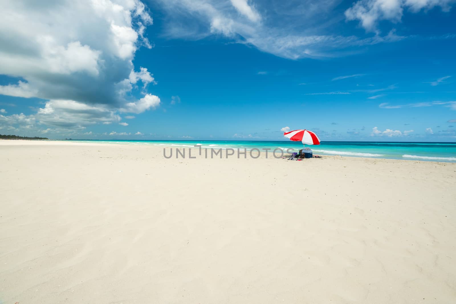 red parasol on the sandy beach by Robertobinetti70