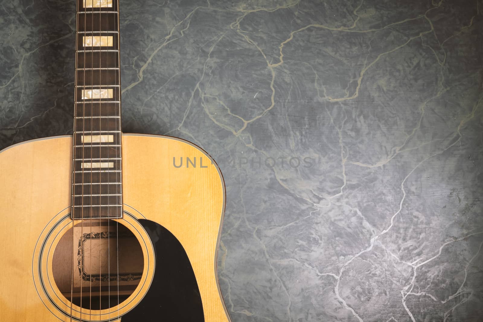 acoustic guitar on green marble background,music concept.