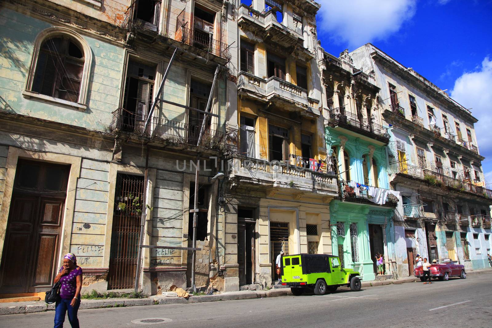 Havana, Cuba - January 10, 2019: Vintage cars moving on the streets of colorful Havana. A great variety of old cars exist In Cuba. On the streets cars from the first half of the 20th century can be found in magnificent conditions, which takes back in history and make the old atmosphere of the cities.