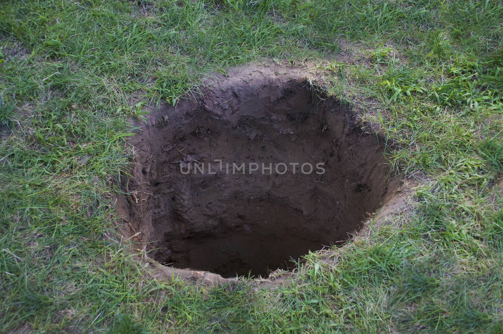 Deep dirt hole in ground or lawn by Balefire9