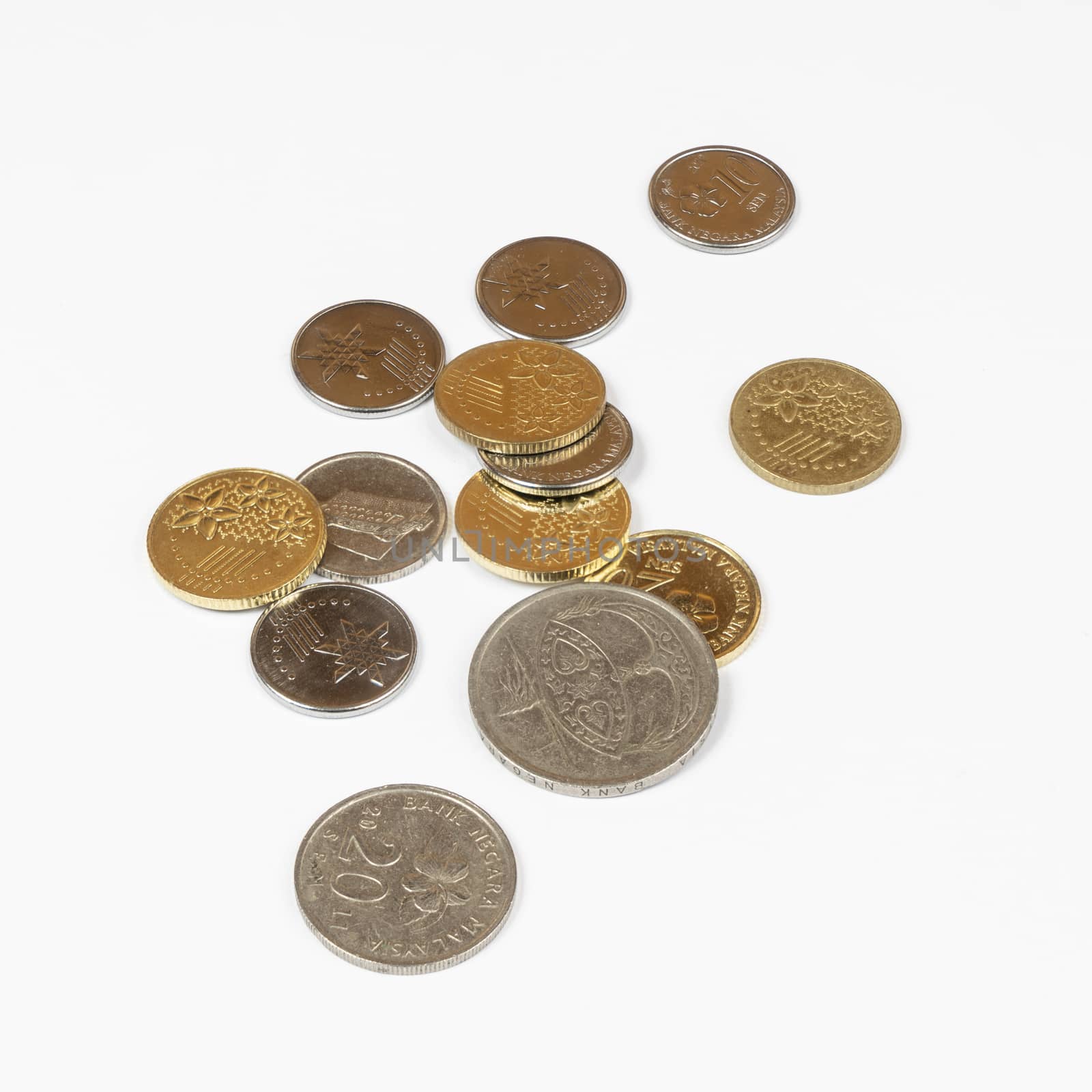 some Malaysian Ringgit coins on a white surface