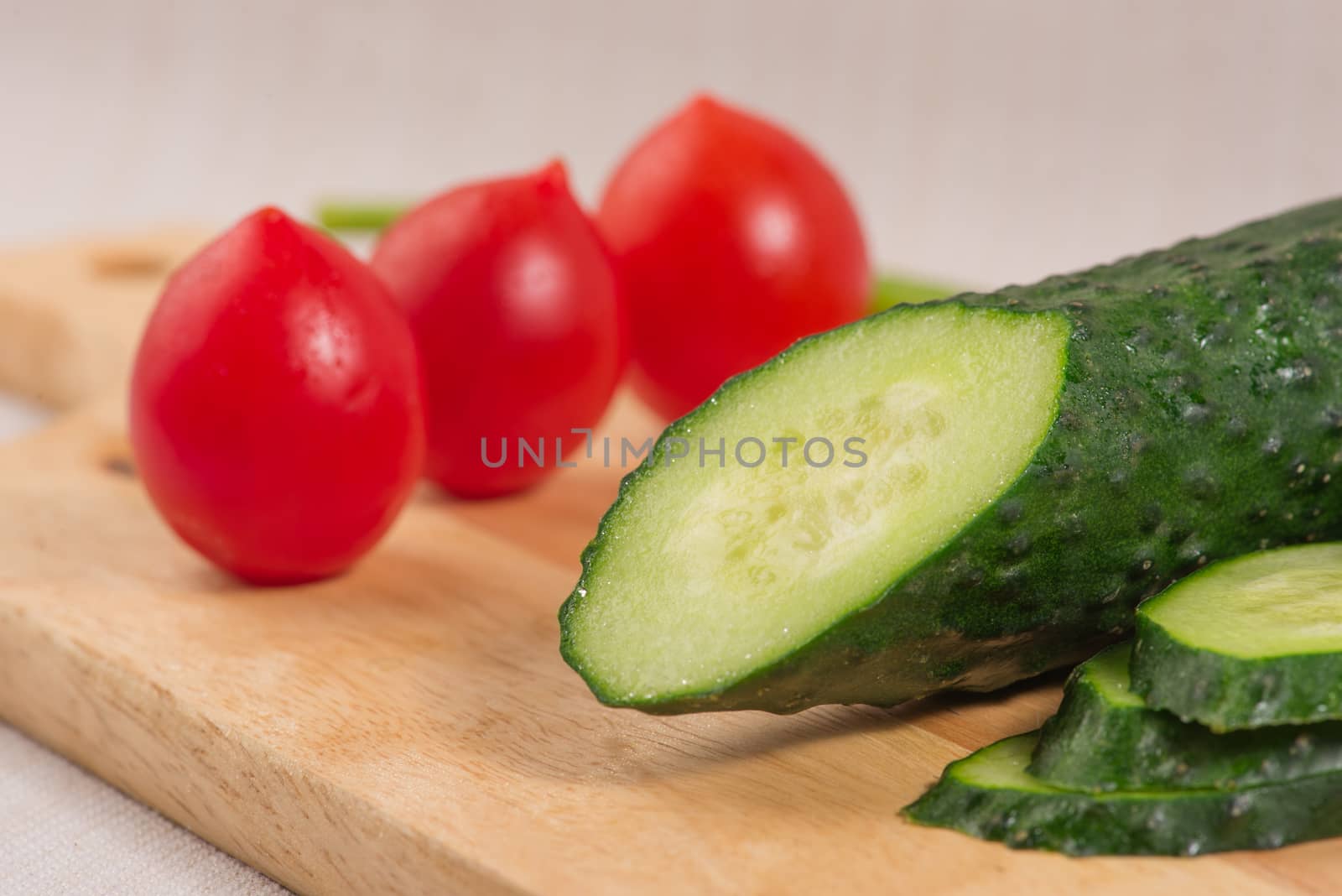 Cucumber, cherry tomatoes on the Board close-up. Selective focus by claire_lucia