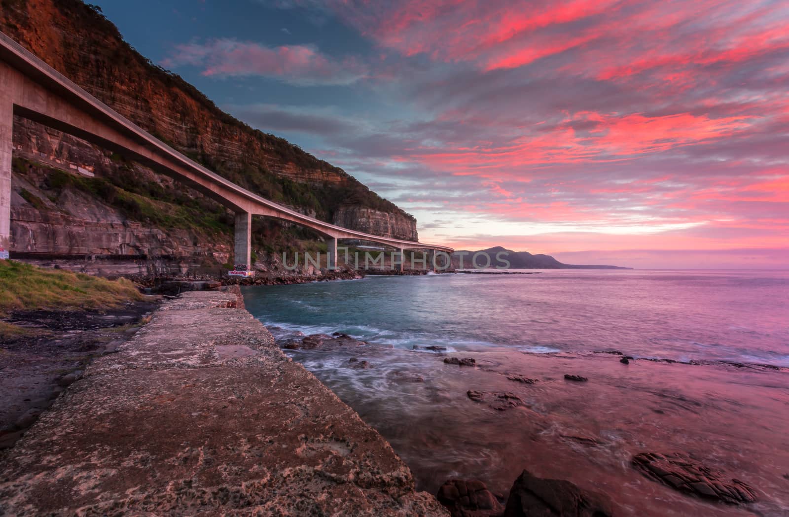 Sea Cliff Bridge and sunrise ocean by lovleah