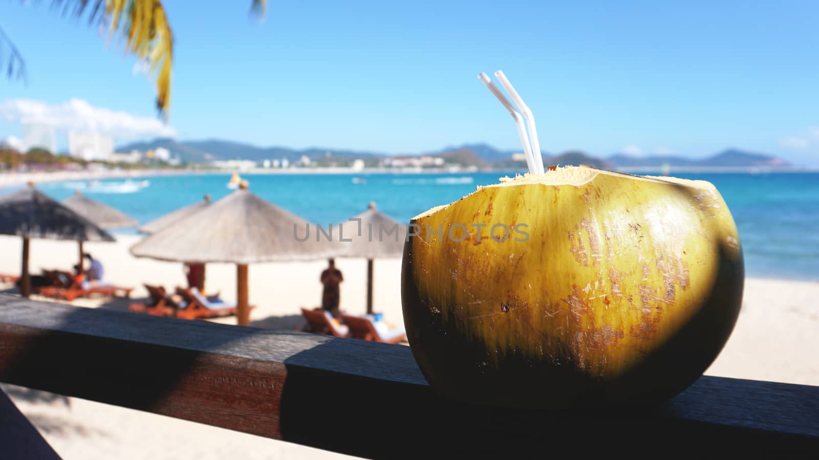 Coconut water drink on a tropical beach. Sea Beach in the background