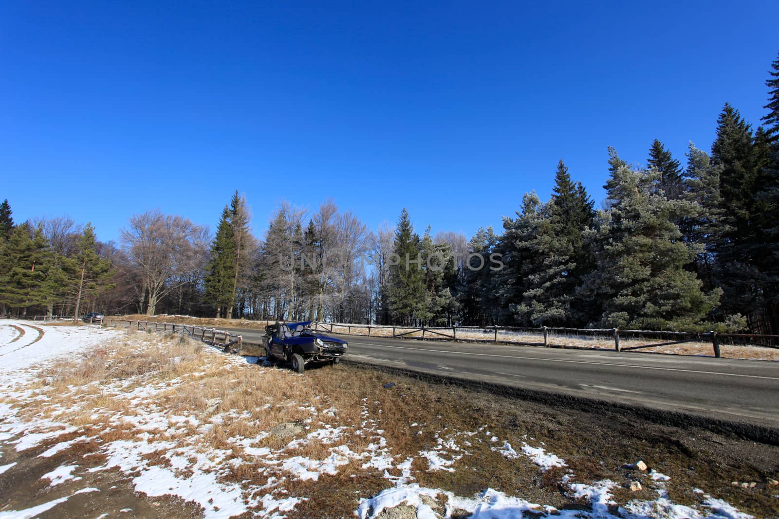 Front of blue car damaged by crash accident on side of the road by PixAchi