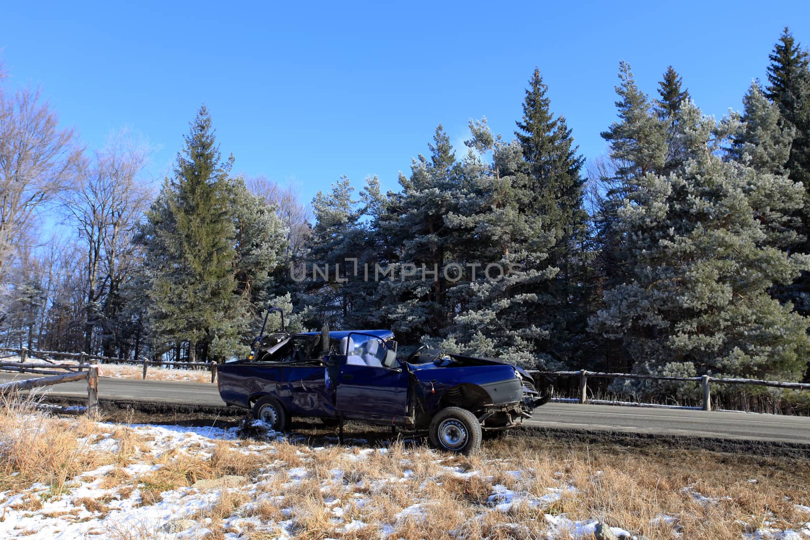 Front of blue car damaged by crash accident on side of the road by PixAchi