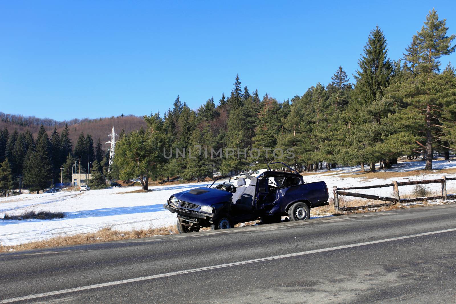 Front of blue car damaged by crash accident on side of the road by PixAchi