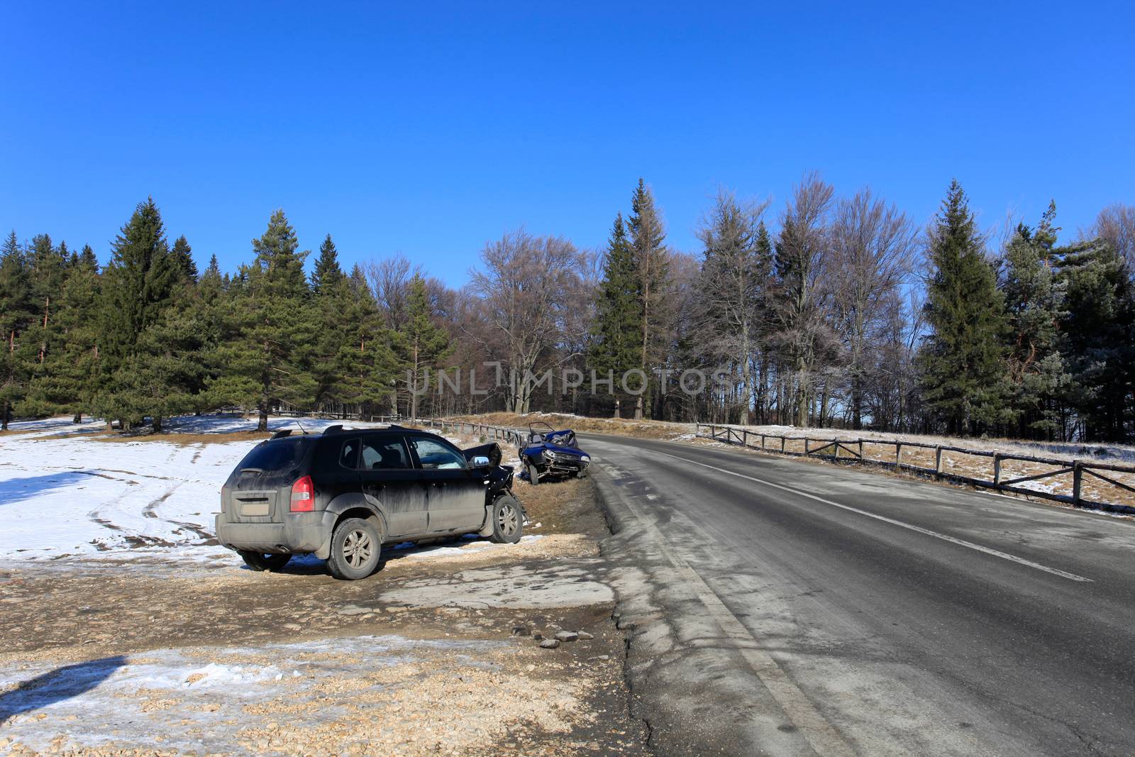 Two cars damaged by crash accident on side of the road