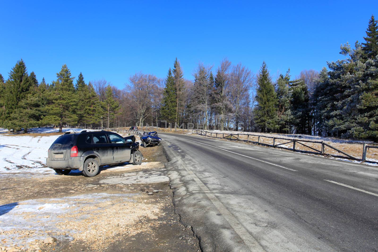 Front of blue car damaged by crash accident on side of the road