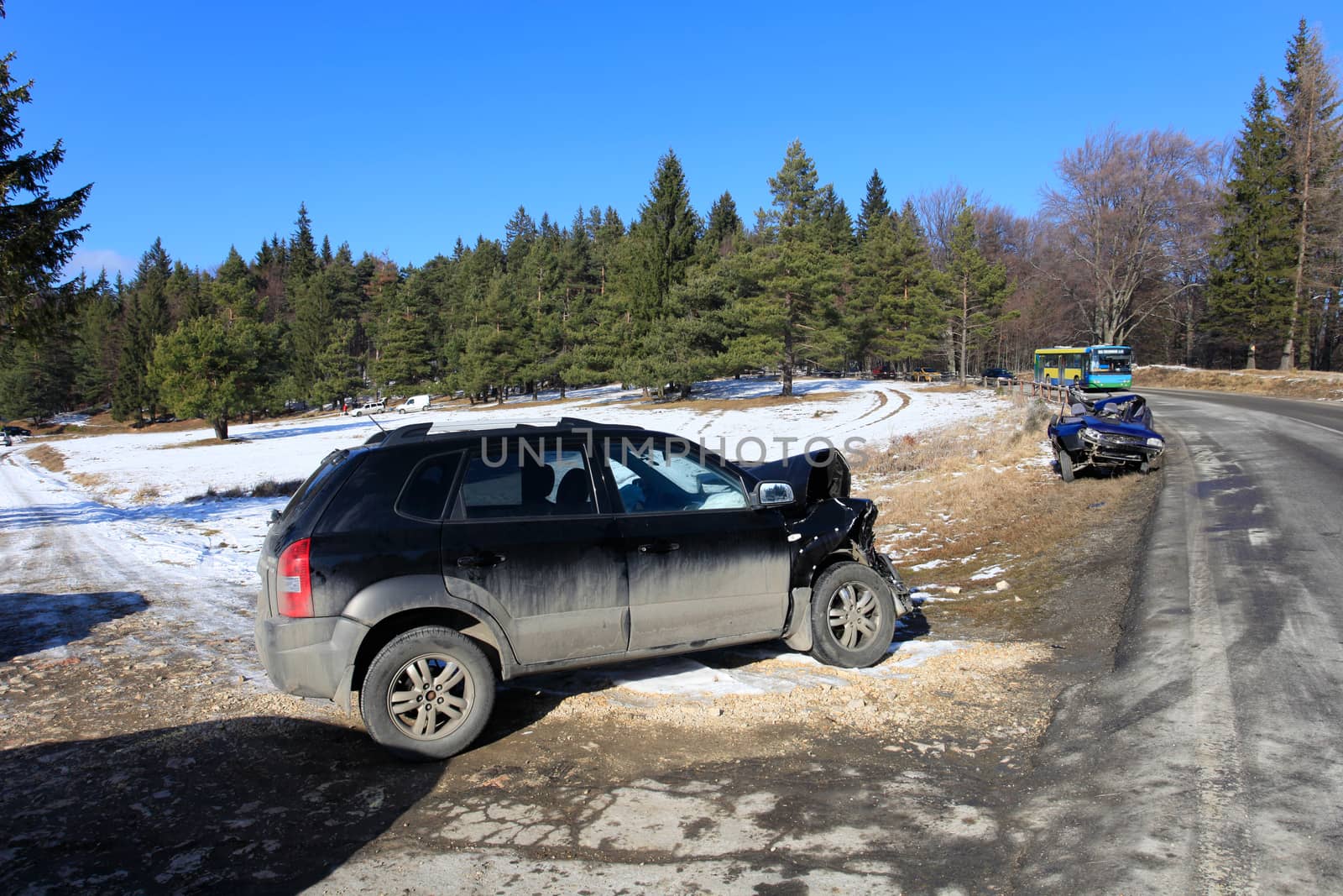 Front of blue car damaged by crash accident on side of the road by PixAchi