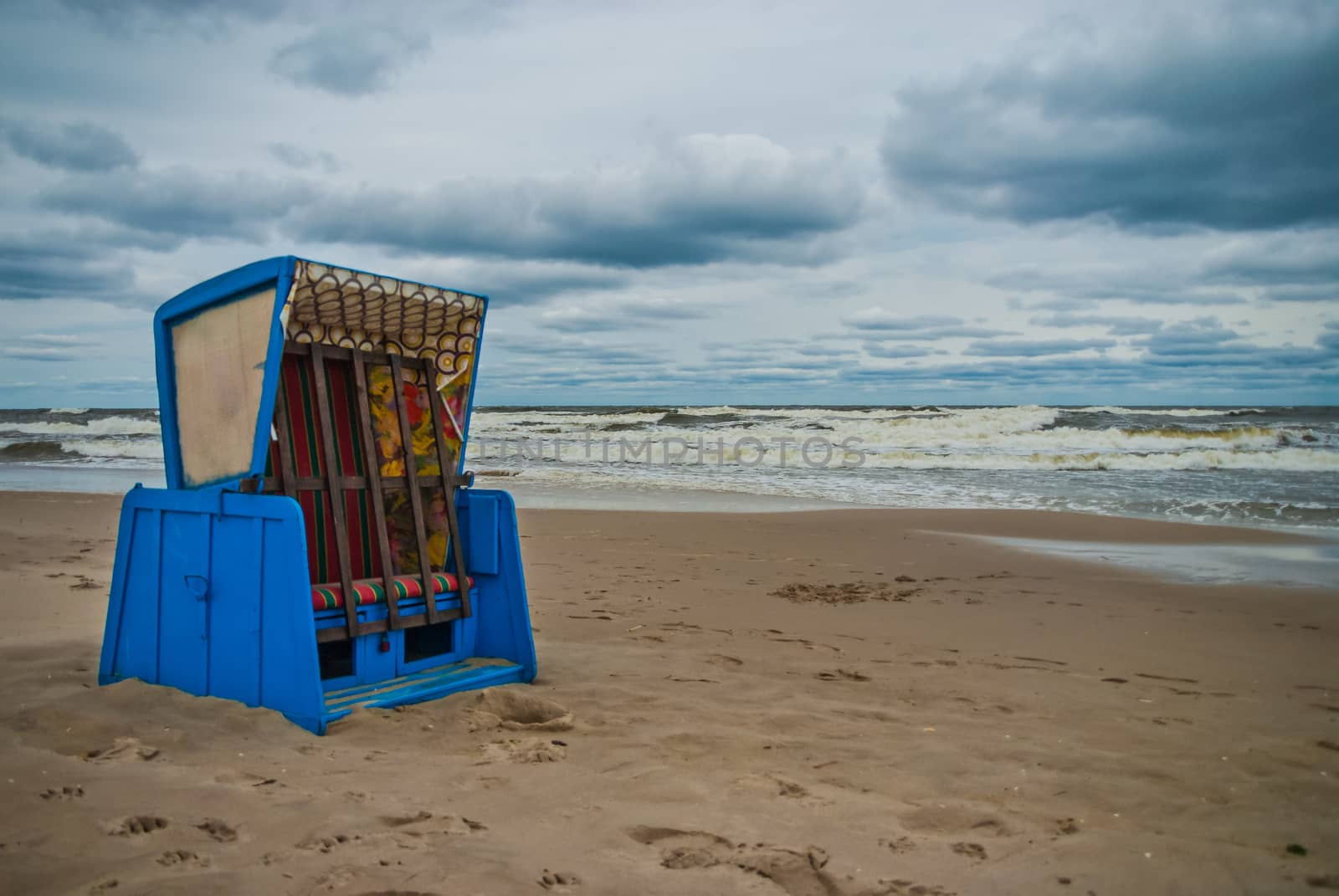 Beach chair at the eastern sea of Germany during summer storm by MXW_Stock