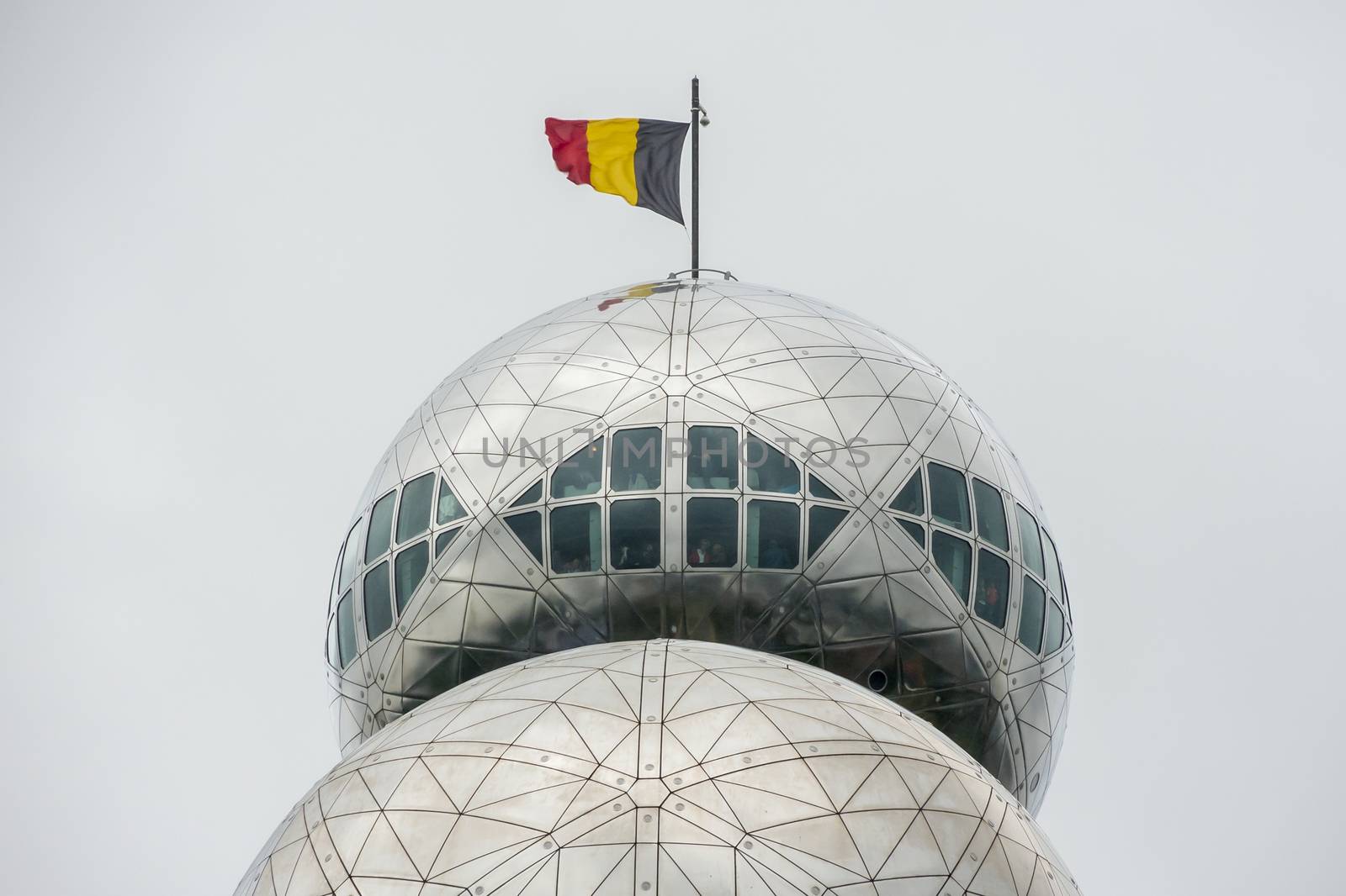 Closeup of the Atomium in Brussels with Belgium flag on the roof by MXW_Stock