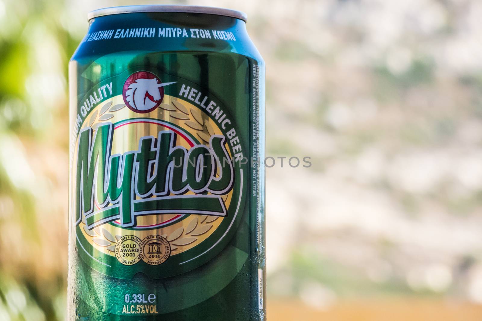 Closeup shot of greek beer in front of blurred natural background
