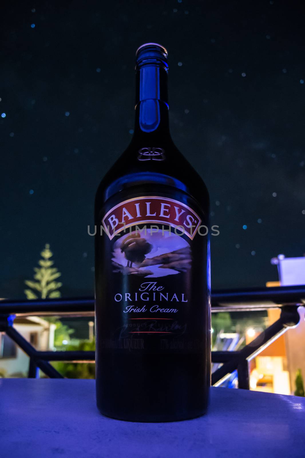 Irish liqueur in front of blurred night sky