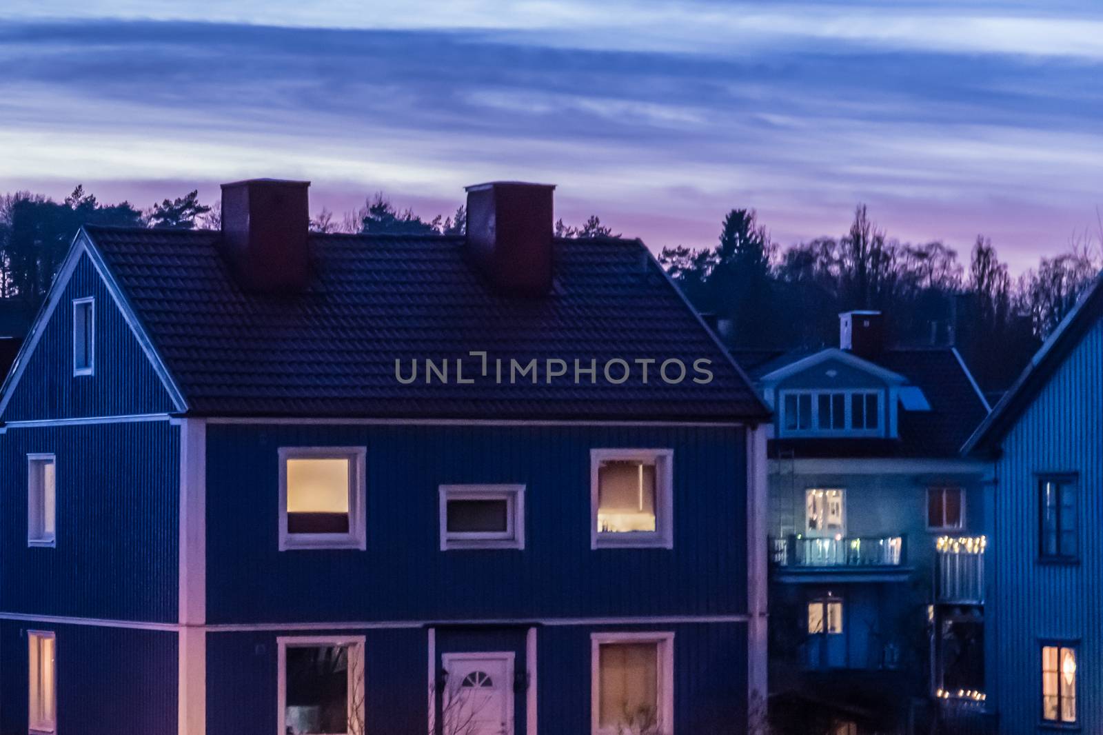 Blue wood house in Gothenburg Sweden sunset by MXW_Stock