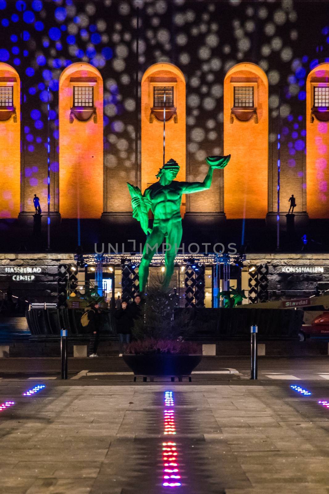 Bronze Statue of Poseidon in Sweden with colorful lights