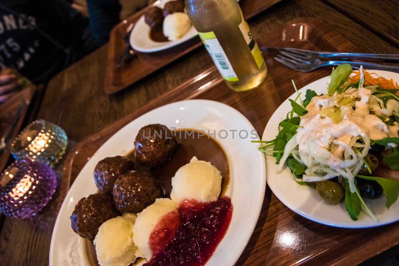 Swedish meatballs with salad, candles and lingonberries