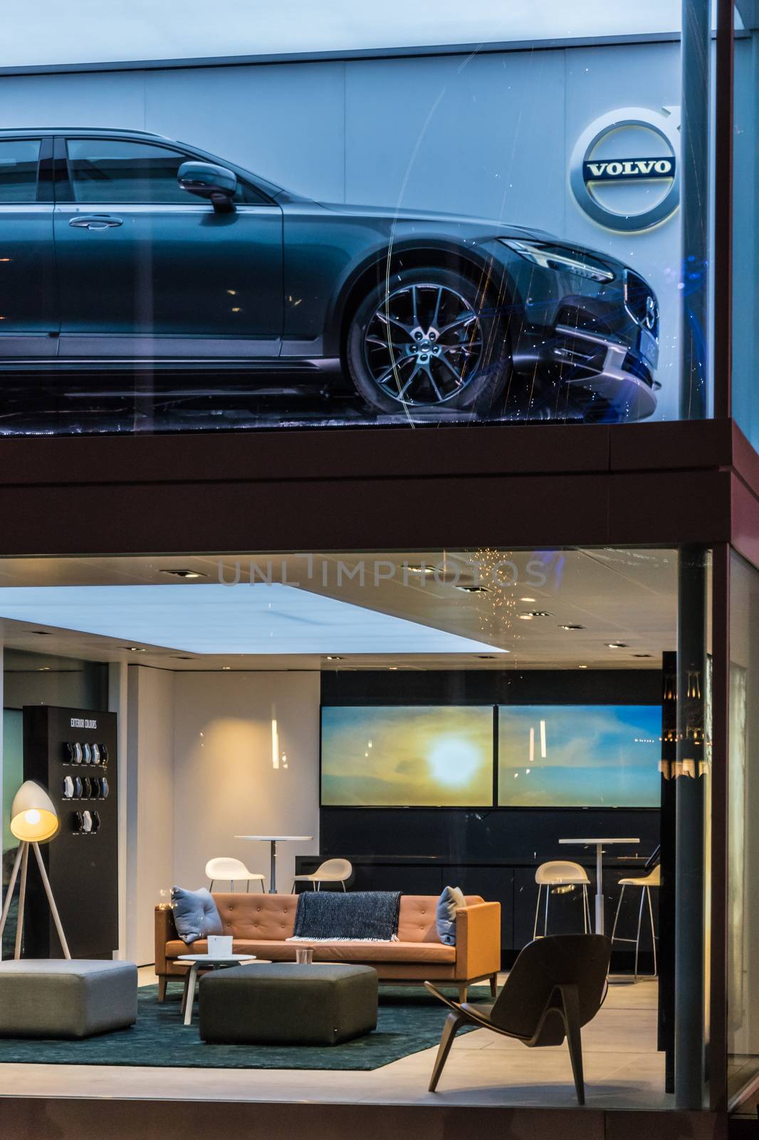 Volvo showroom with car on the upper and stylish furniture and t by MXW_Stock