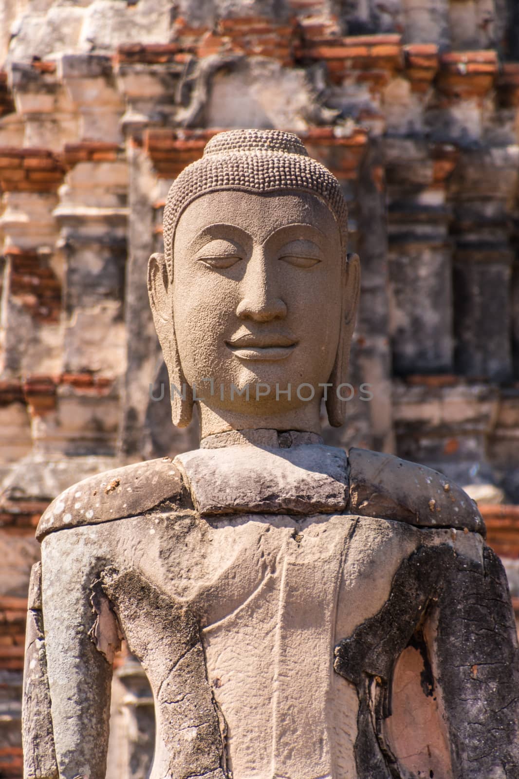Ancient statue of Buddha in a ruin of buddhist brick temple