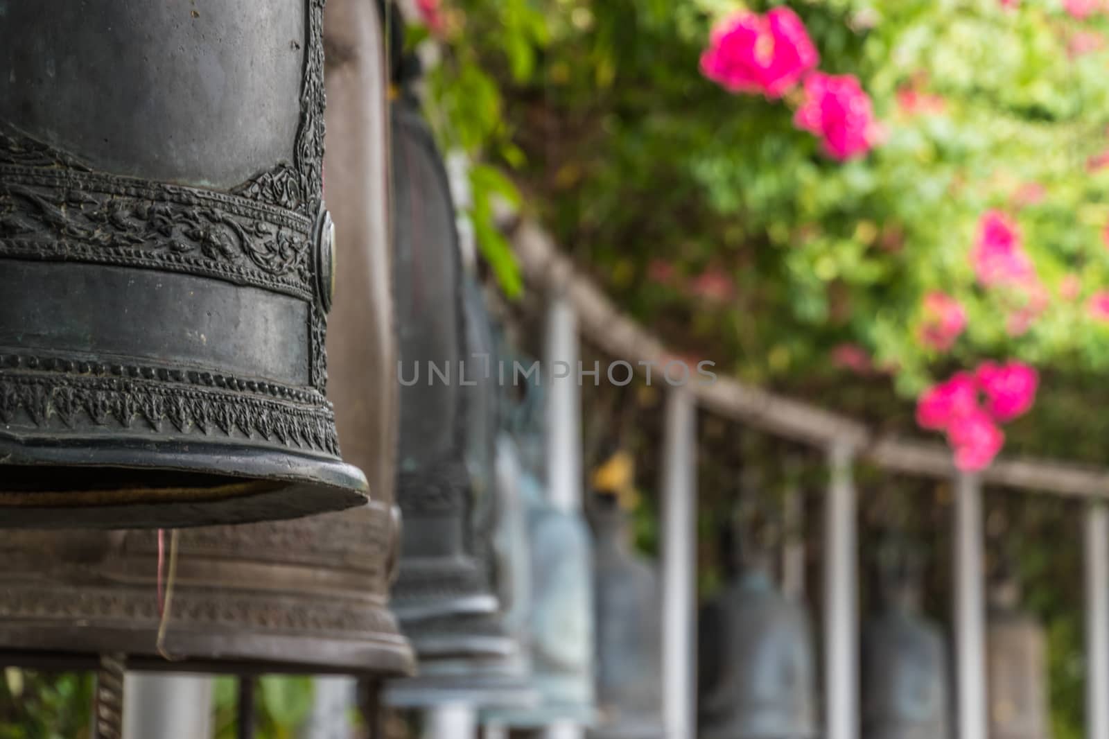 Bells in buddhist temple in Bangkok Thailand by MXW_Stock