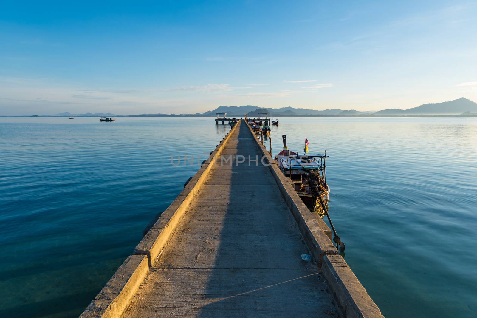 Ship boat dock at calm sea blue water and sky by MXW_Stock