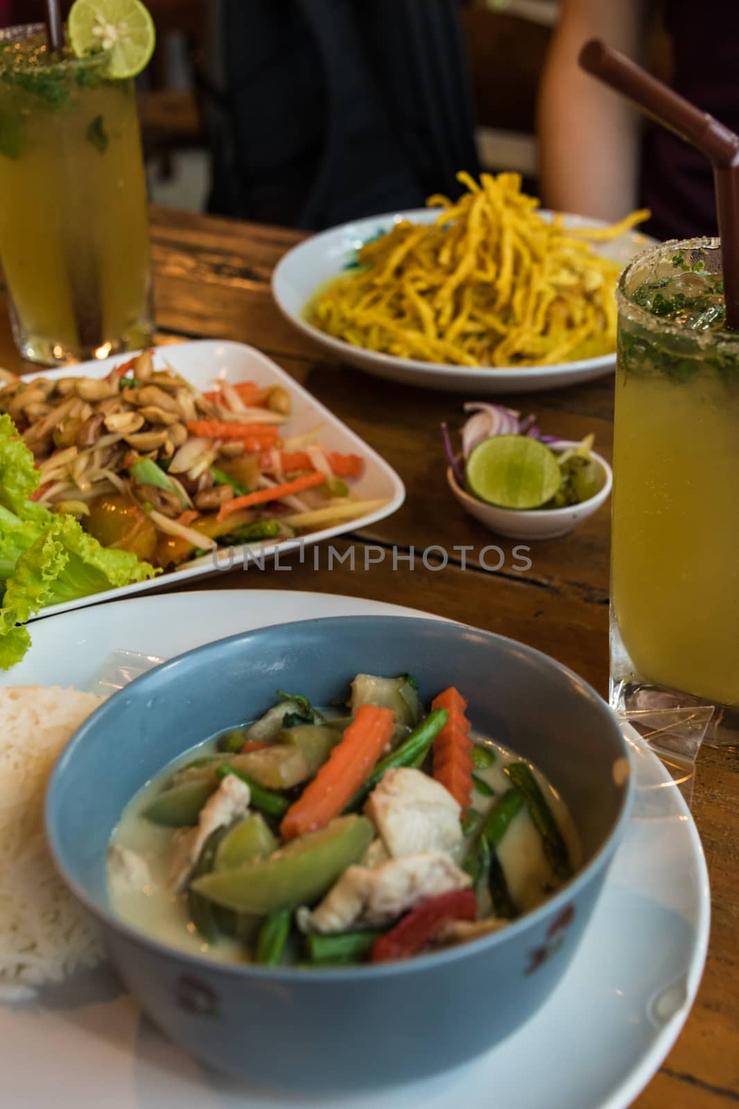 Typical thai food papaya salad, thai cocktail, curry