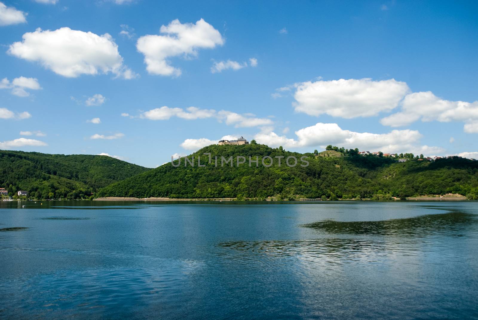 Castle on top of hill at Edersee Germany sea water sky forrest by MXW_Stock
