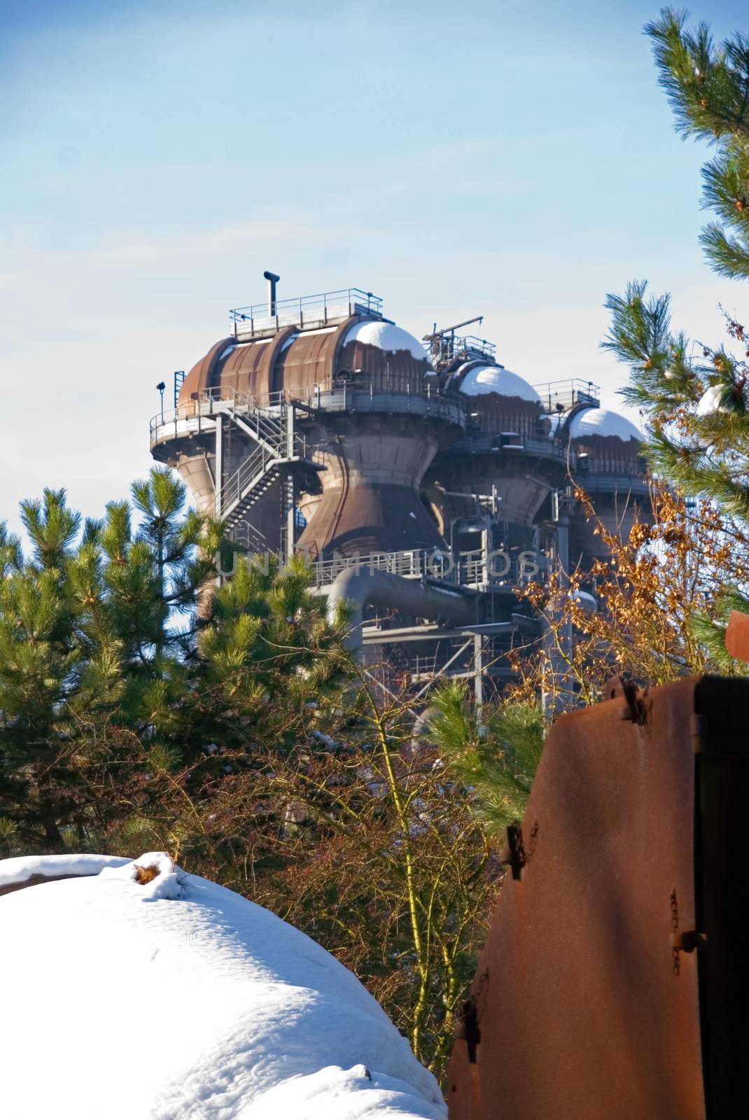 Industrial plant pipeline furnace in winter snow rust steel