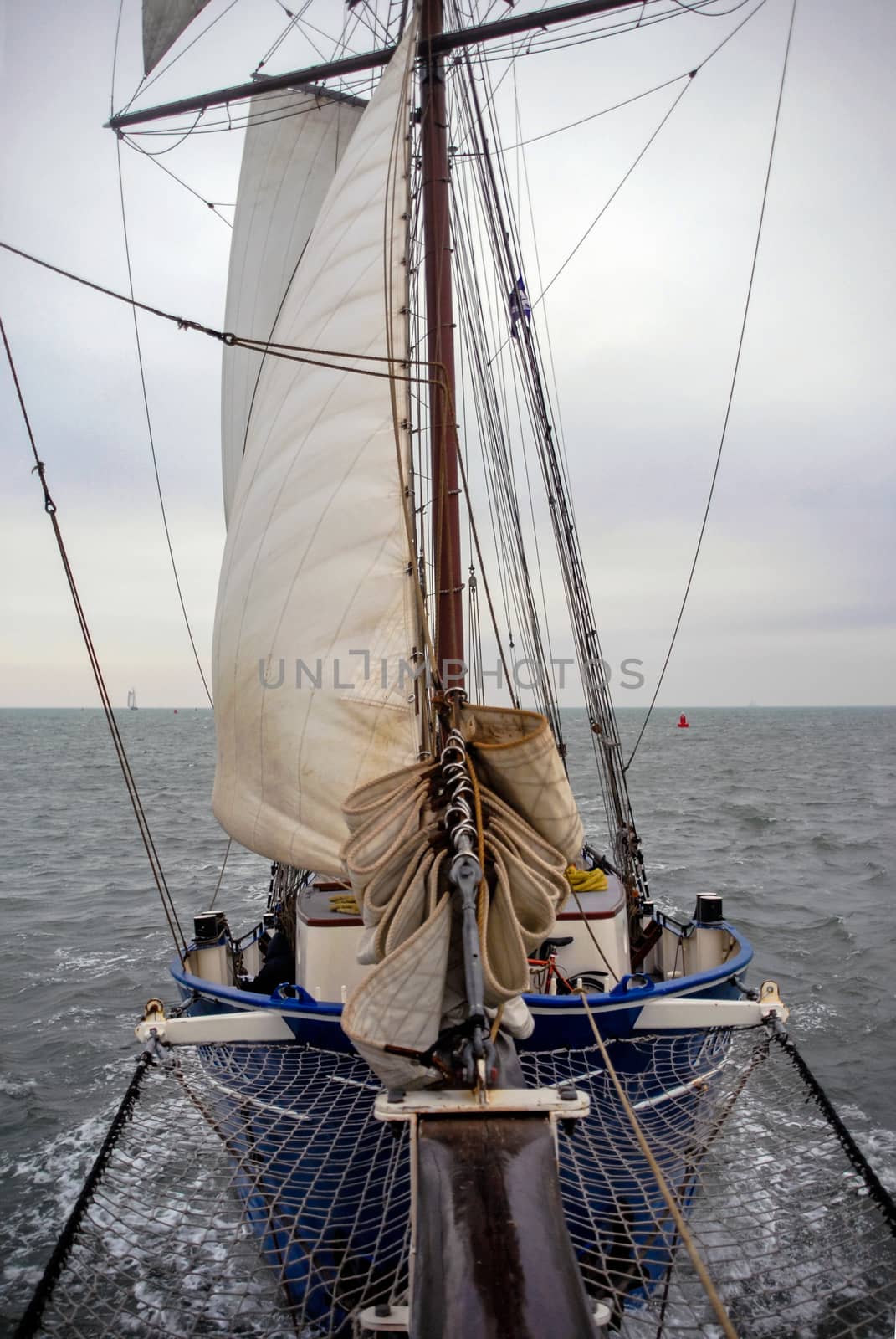 Sailing boat on Nothern Sea sails wind water storm front view by MXW_Stock