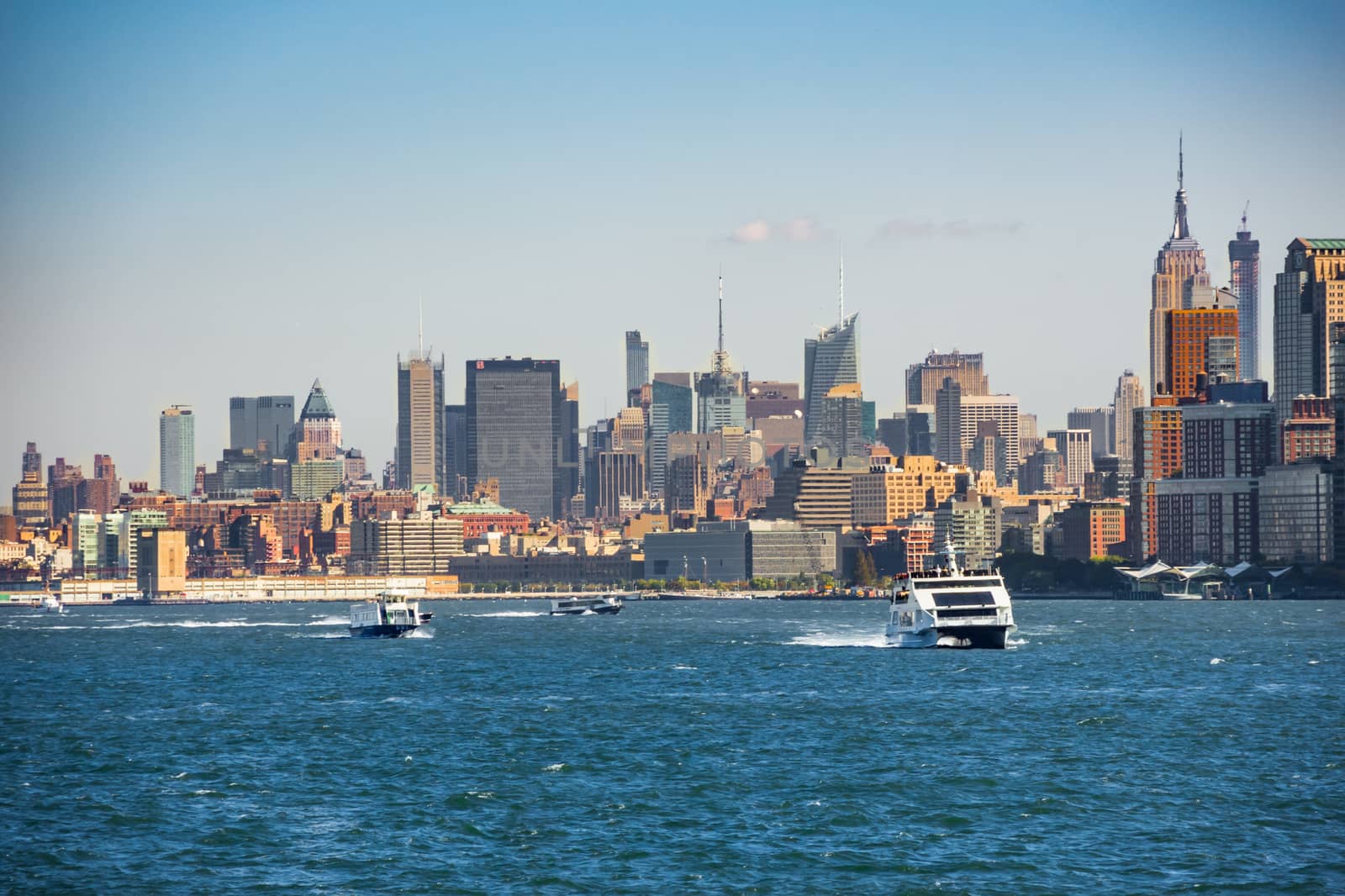 Boats on Hudson River in front of New York Skyline by MXW_Stock