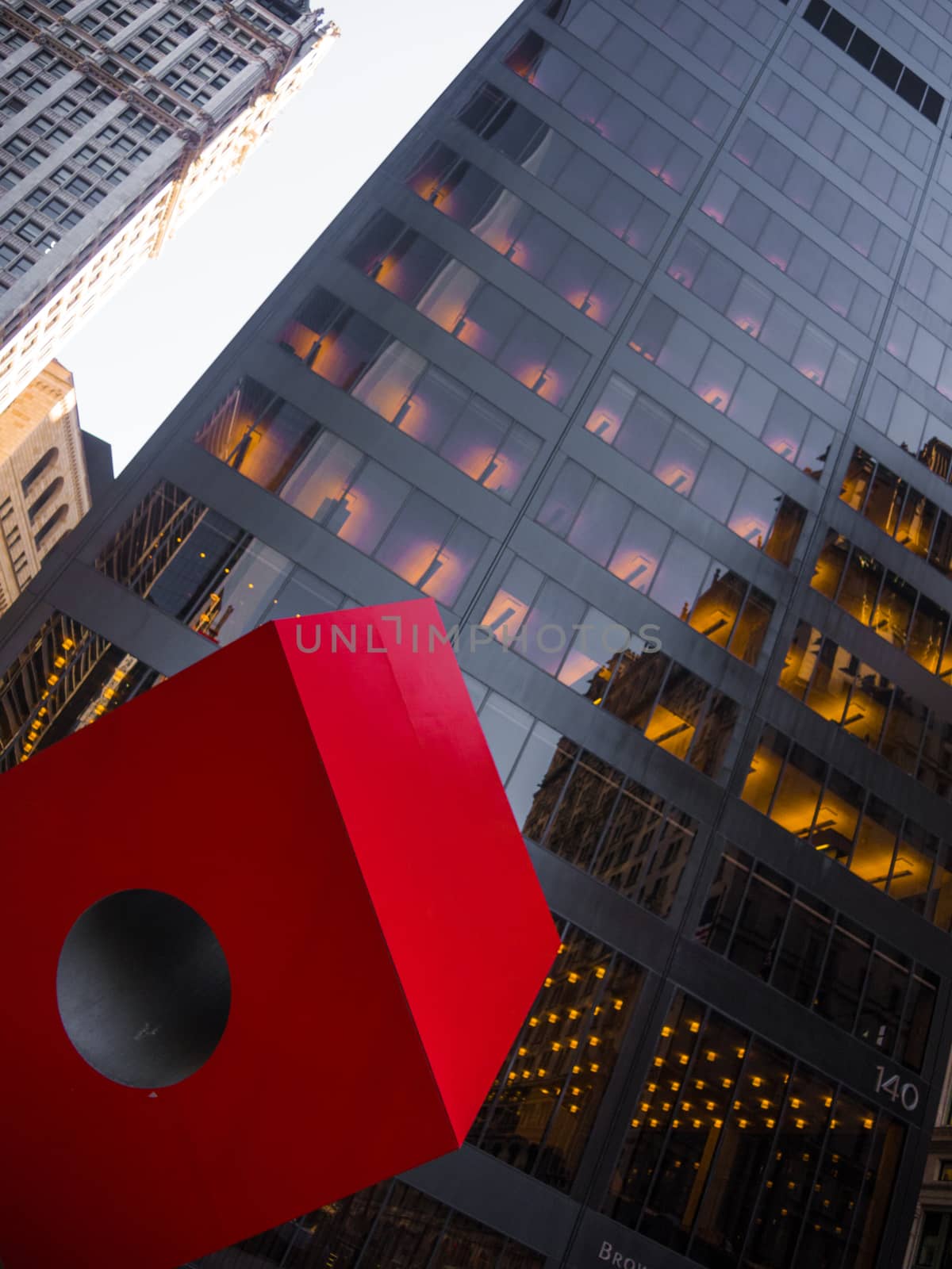 Red cube die in front of black facade Manhattan Downtown Skyscra by MXW_Stock