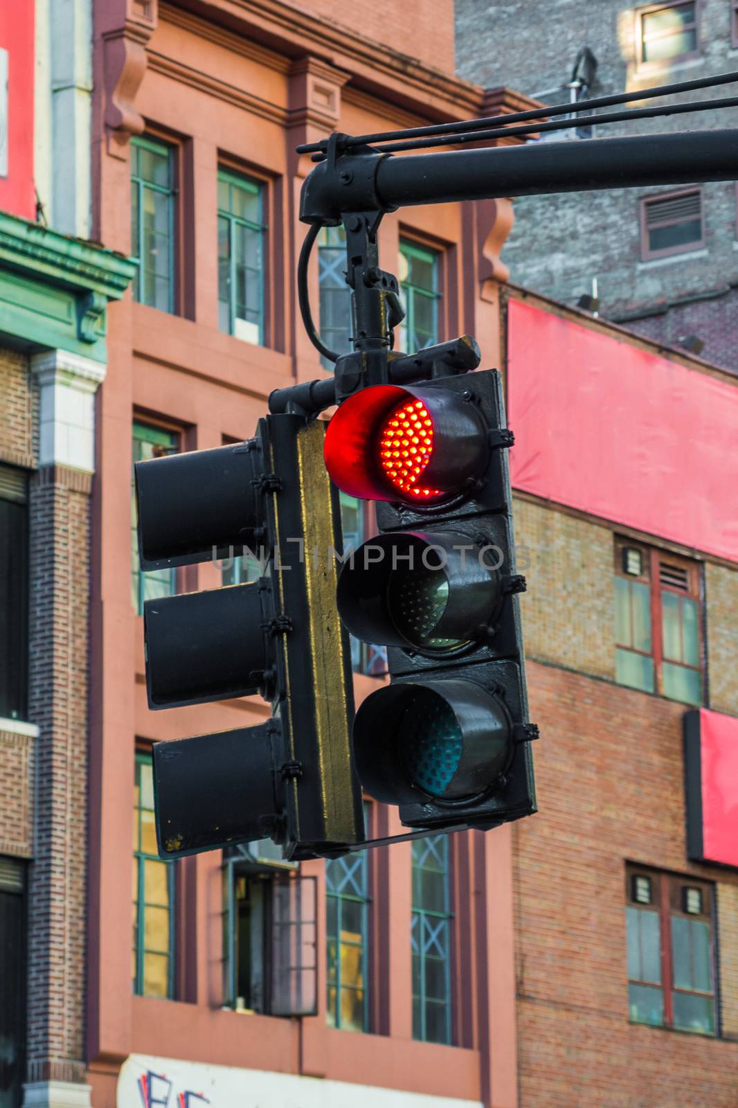 Red traffic light signal hanging in streets of New York by MXW_Stock