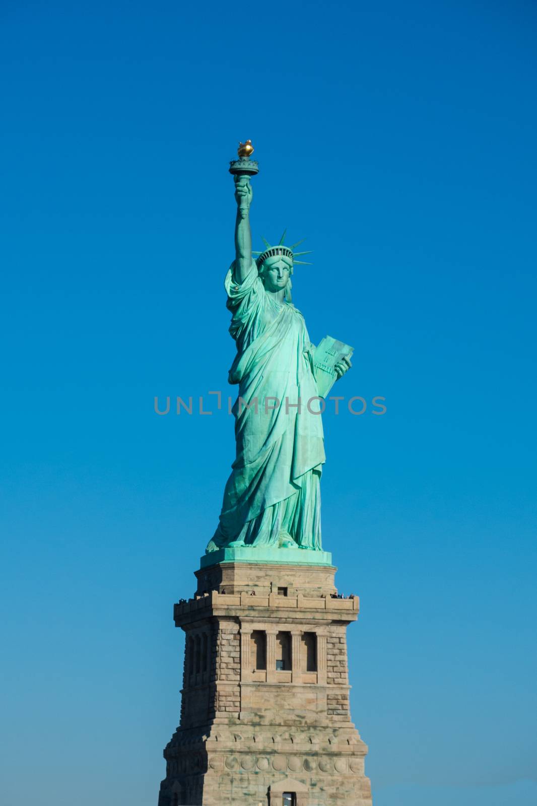 Statue of Liberty at perfect weather conditions blue sky copper