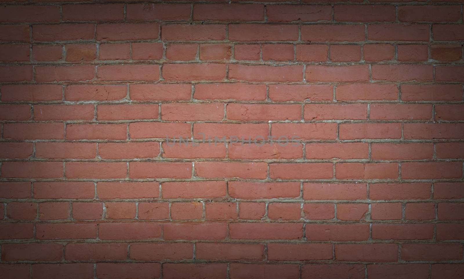 Seamless red brick wall background texture vignetted around edges