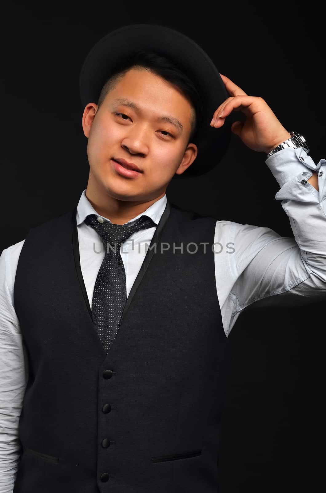 Photo of an Asian man, he raises his hat by congratulating