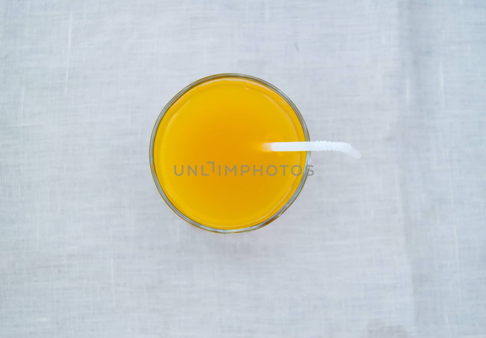 Fresh orange juice in glass with straw, top view by claire_lucia