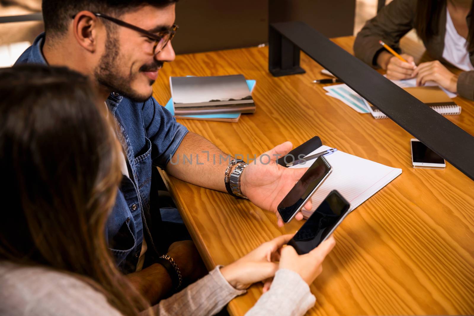 Group of young students watching something on the phone