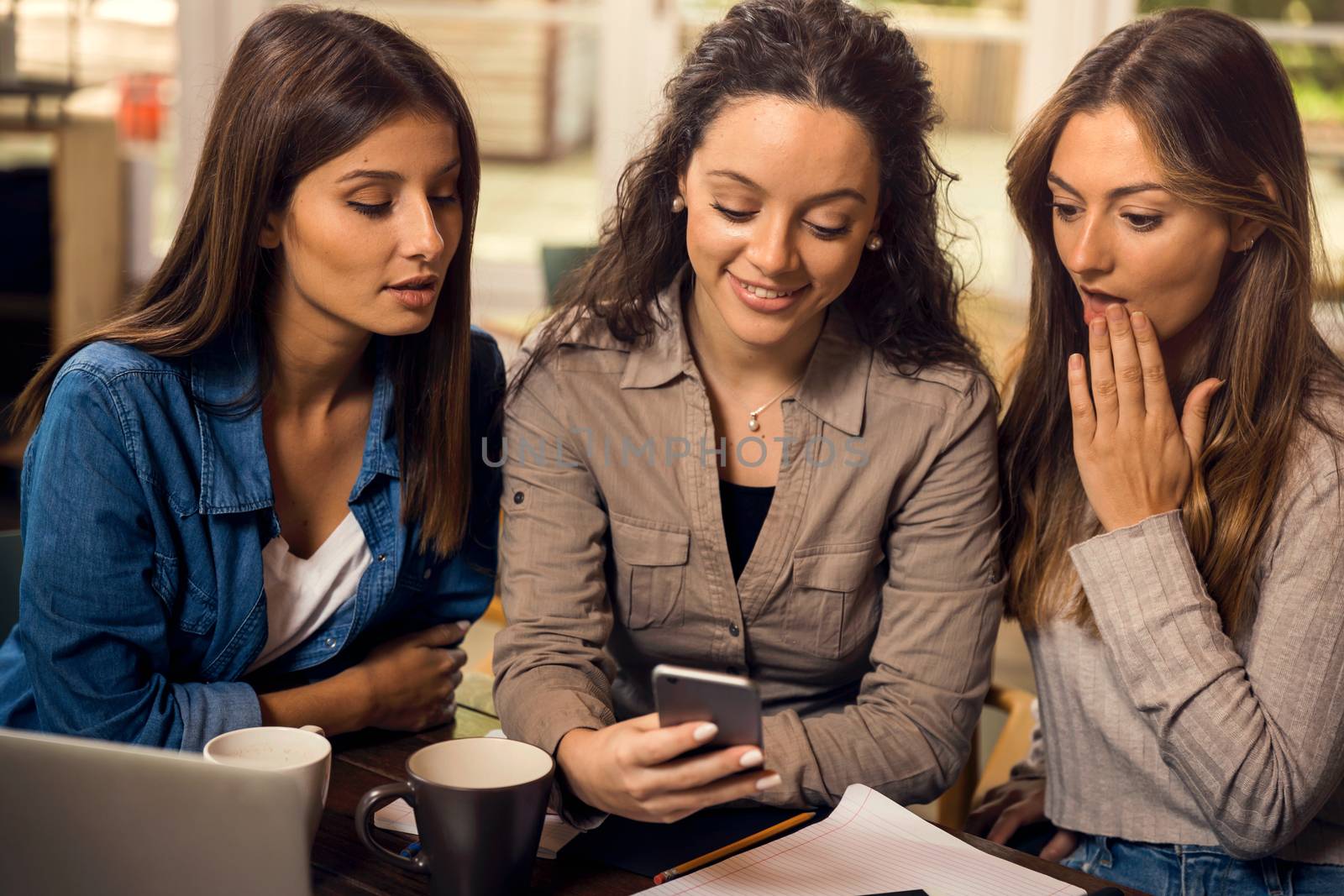 Group of girls making a pause on the studies for some gossip