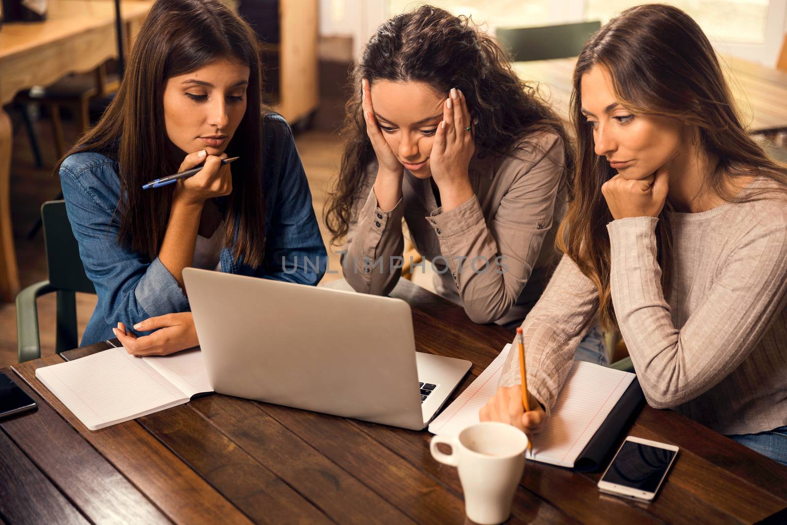 Group of friends studying together and worried with final exams