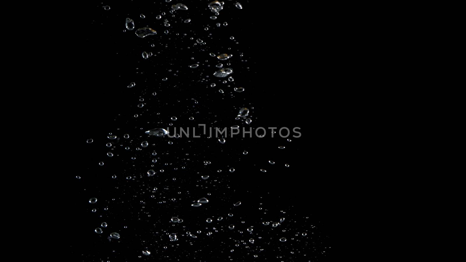 Extream close-up images of water bubbles or soda or liquid texture that splashing and floating up to surface like a explosion in black color background for refreshing carbonate drink concept.