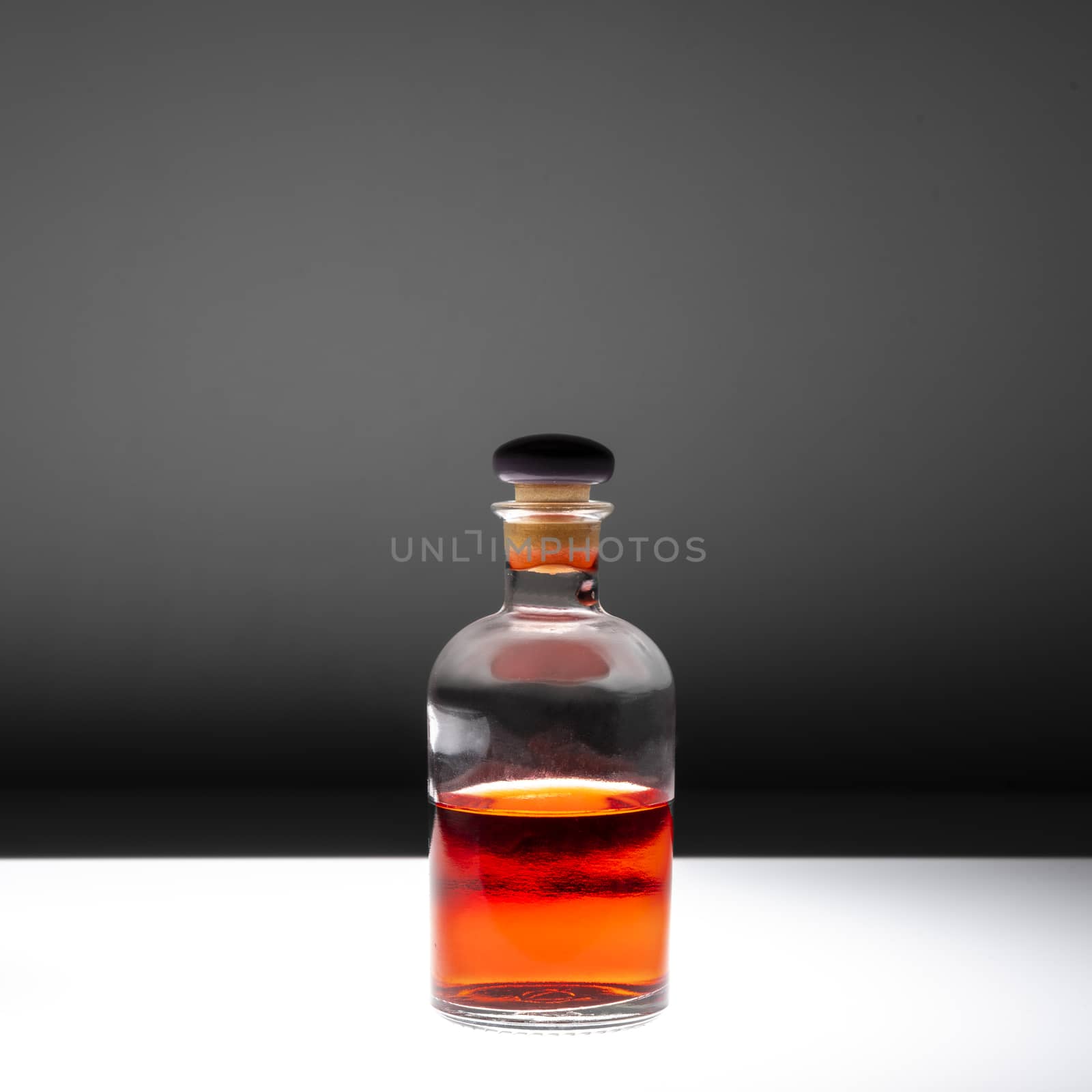Small glass bottle containing red liquid