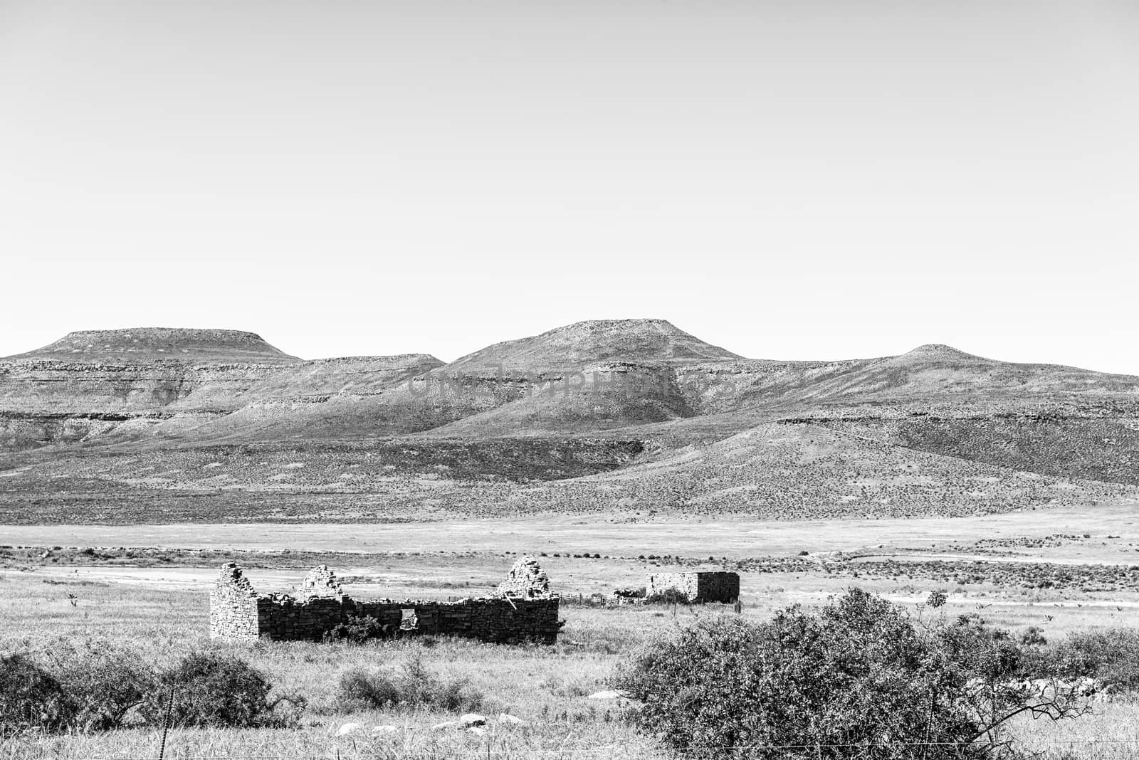 A farm landscape with ruins on road R364 below the Klipfontein Pass in the Cederberg Mountains of the Western Cape Province. Monochrome