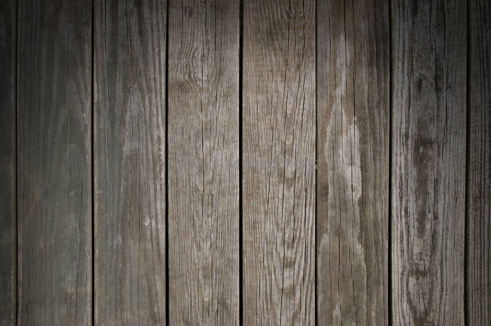 Weathered wooden planking background texture lit from above