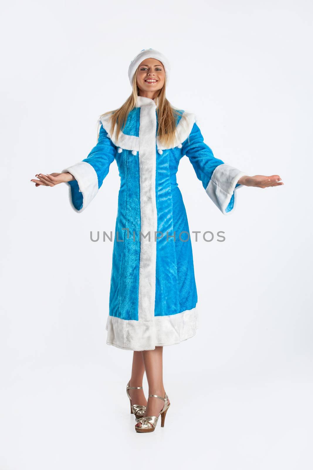 Young beautiful girl in a carnival clothing on a studio background