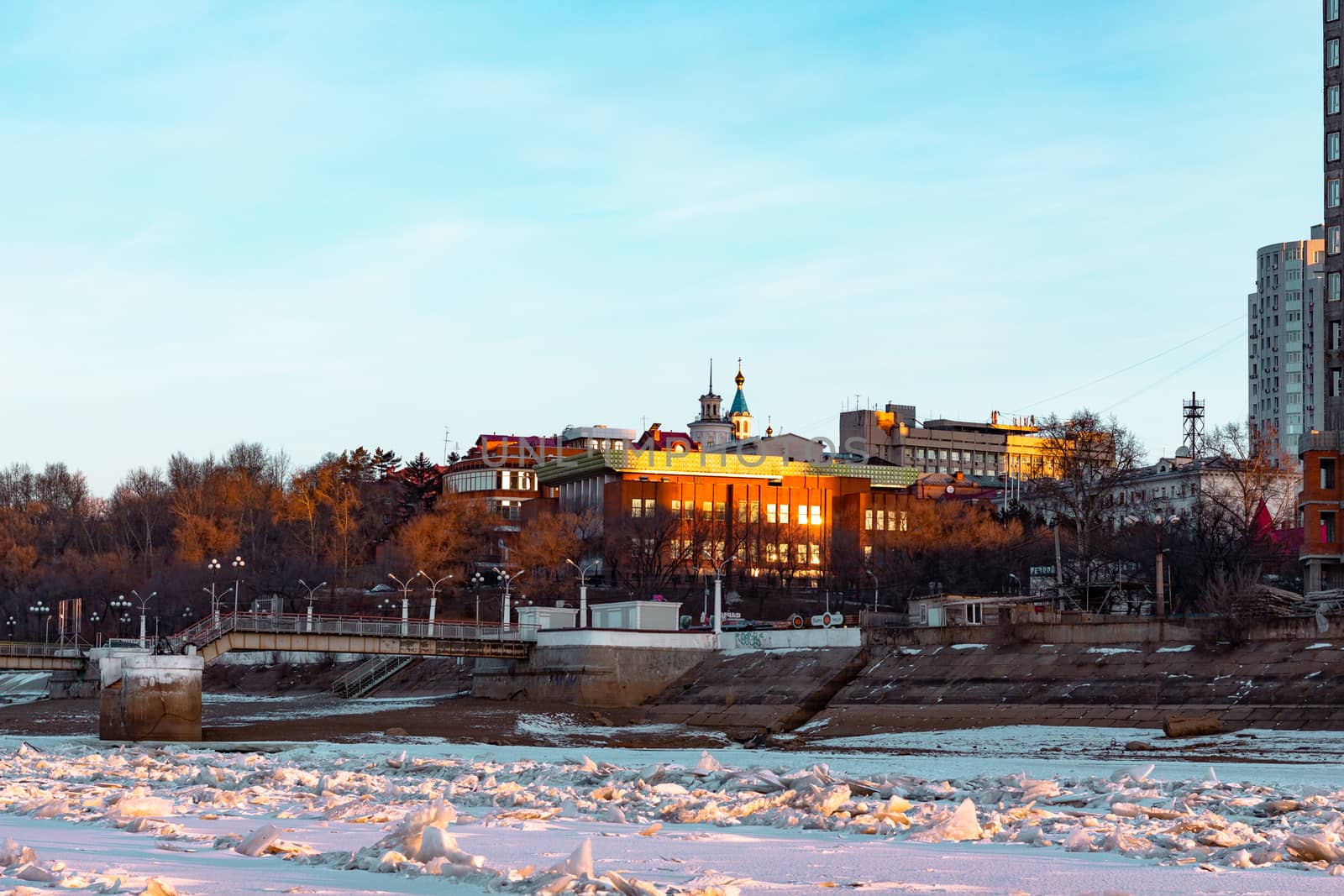 View of the city of Khabarovsk from the Amur river at dawn. Frozen river. The industrial look. by rdv27