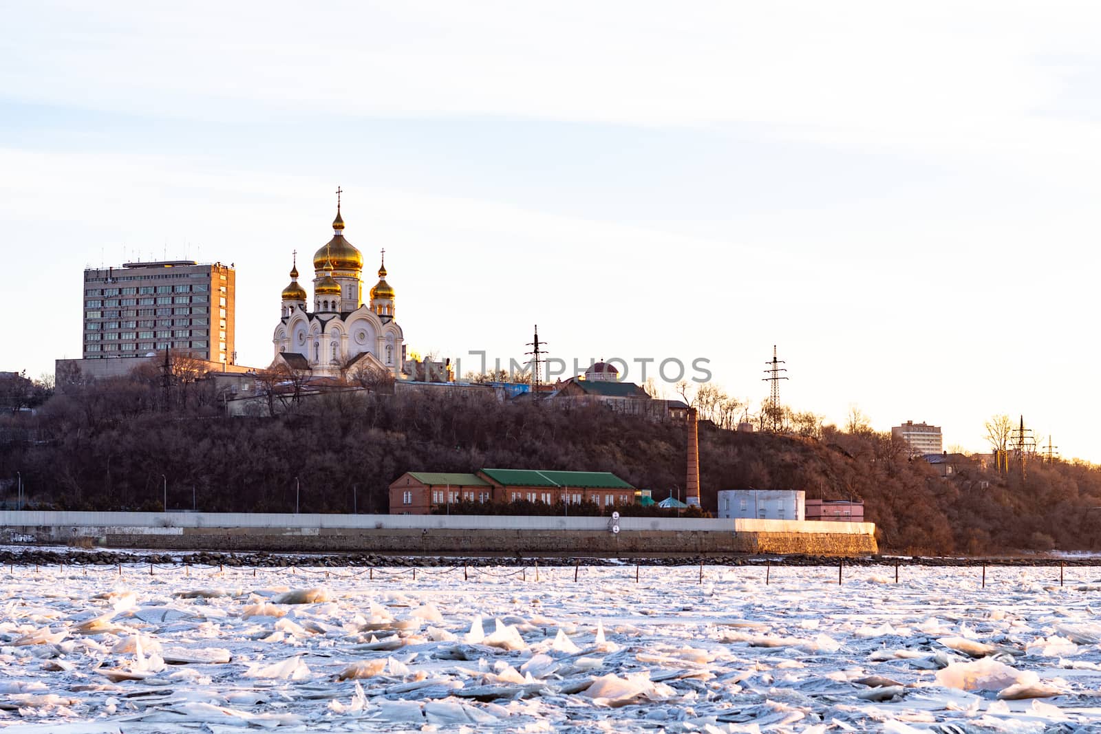 View of the city of Khabarovsk from the Amur river at dawn. Frozen river. The industrial look. by rdv27