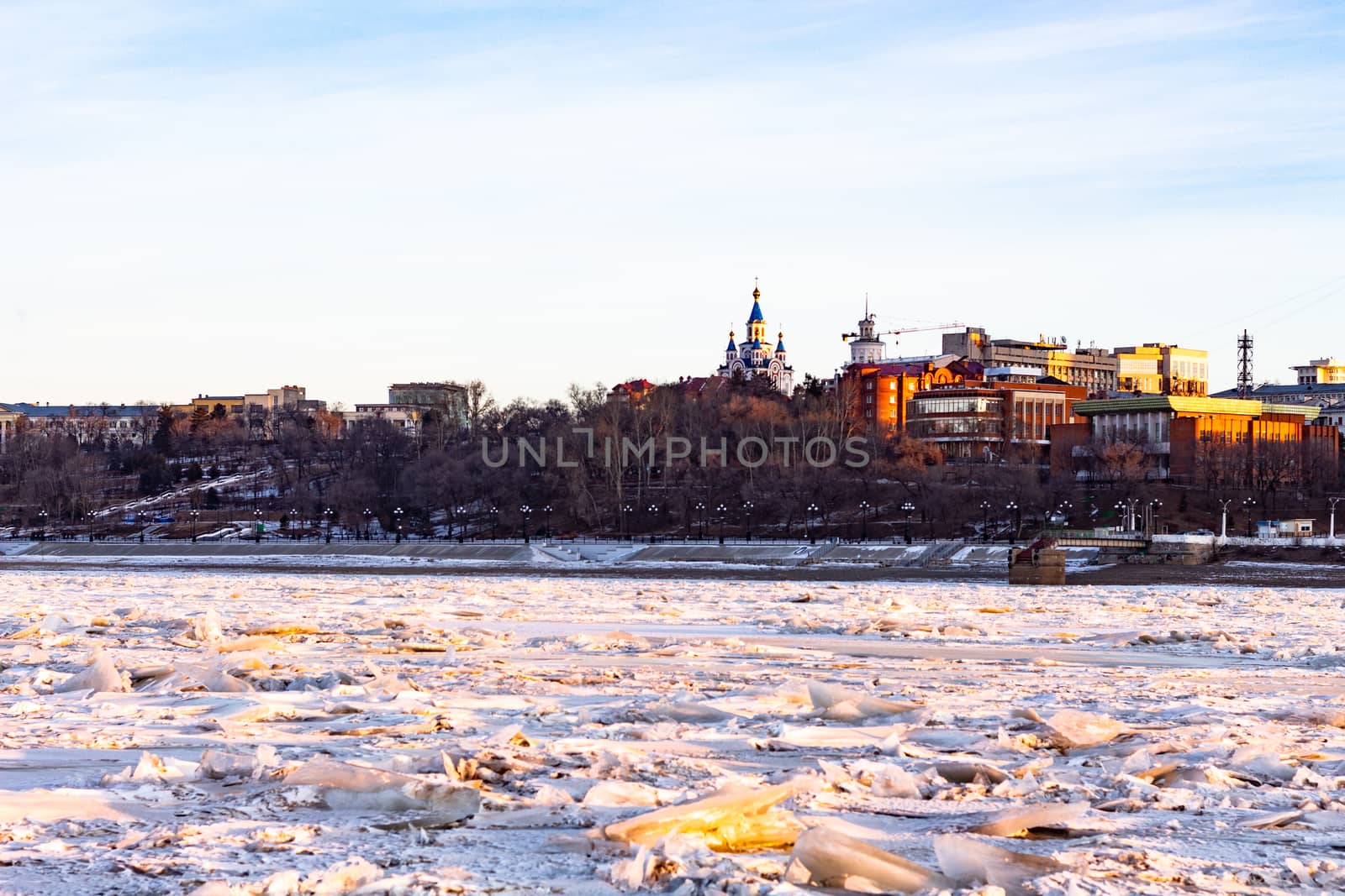 View of the city of Khabarovsk from the Amur river at dawn. Frozen river. The industrial look. by rdv27