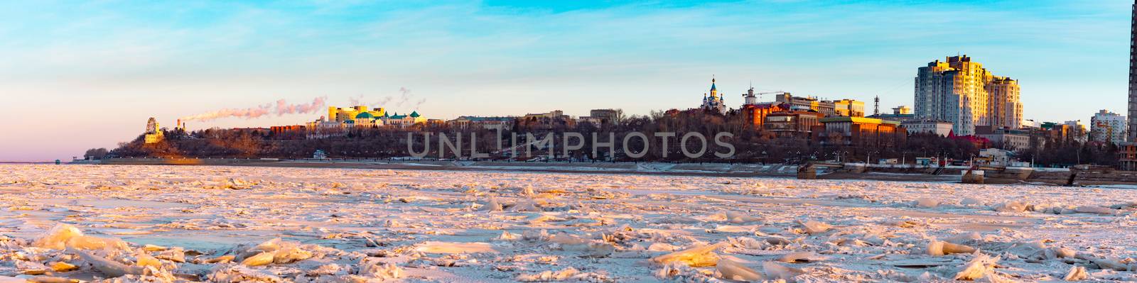 View of the city of Khabarovsk from the Amur river at dawn. Frozen river. The industrial look. by rdv27