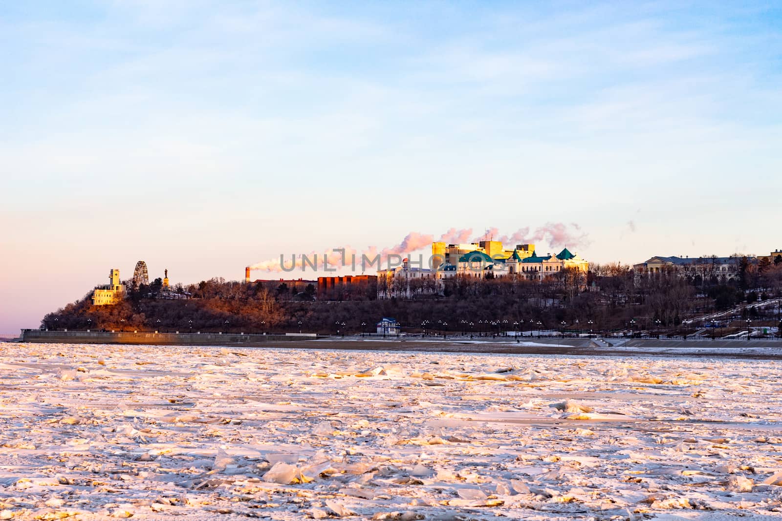 View of the city of Khabarovsk from the Amur river at dawn. Frozen river. The industrial look. by rdv27