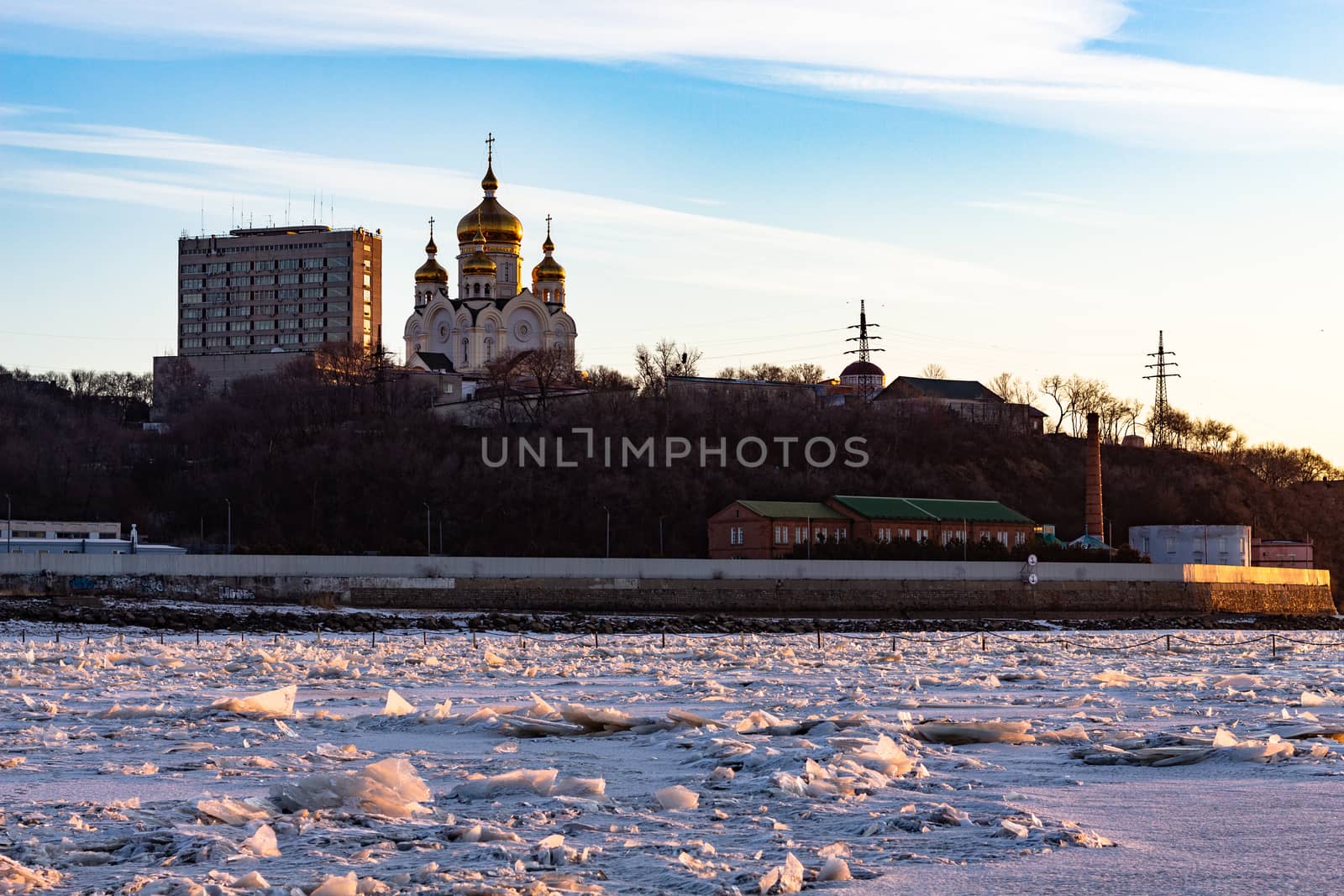 View of the city of Khabarovsk from the Amur river at dawn. Frozen river. The industrial look. by rdv27